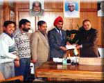 Staff 			handing over draft for C.M. relief fund